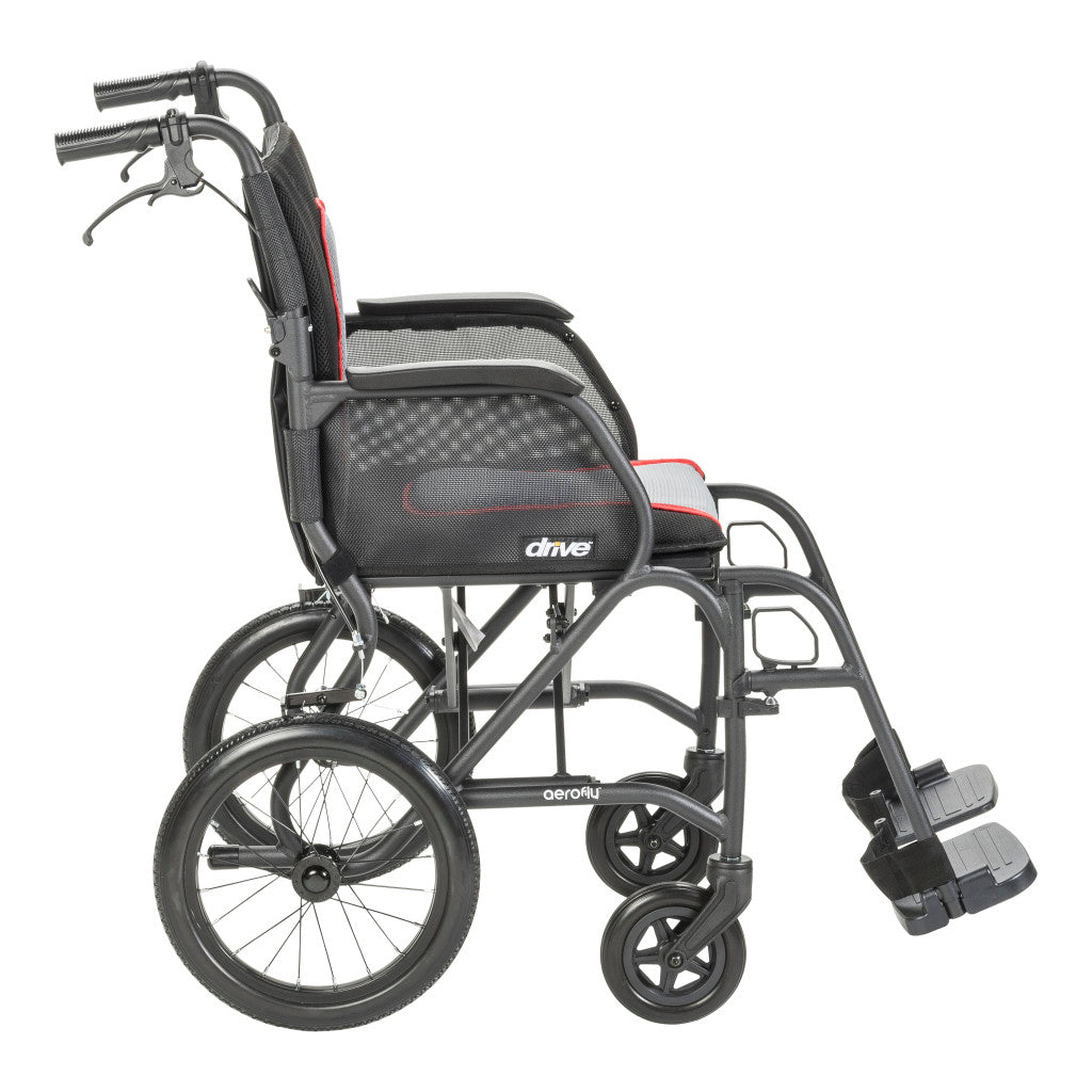 Side view of the black AeroFly transport wheelchair showing padded armrests, rear wheels, caregiver handles, and footrests.