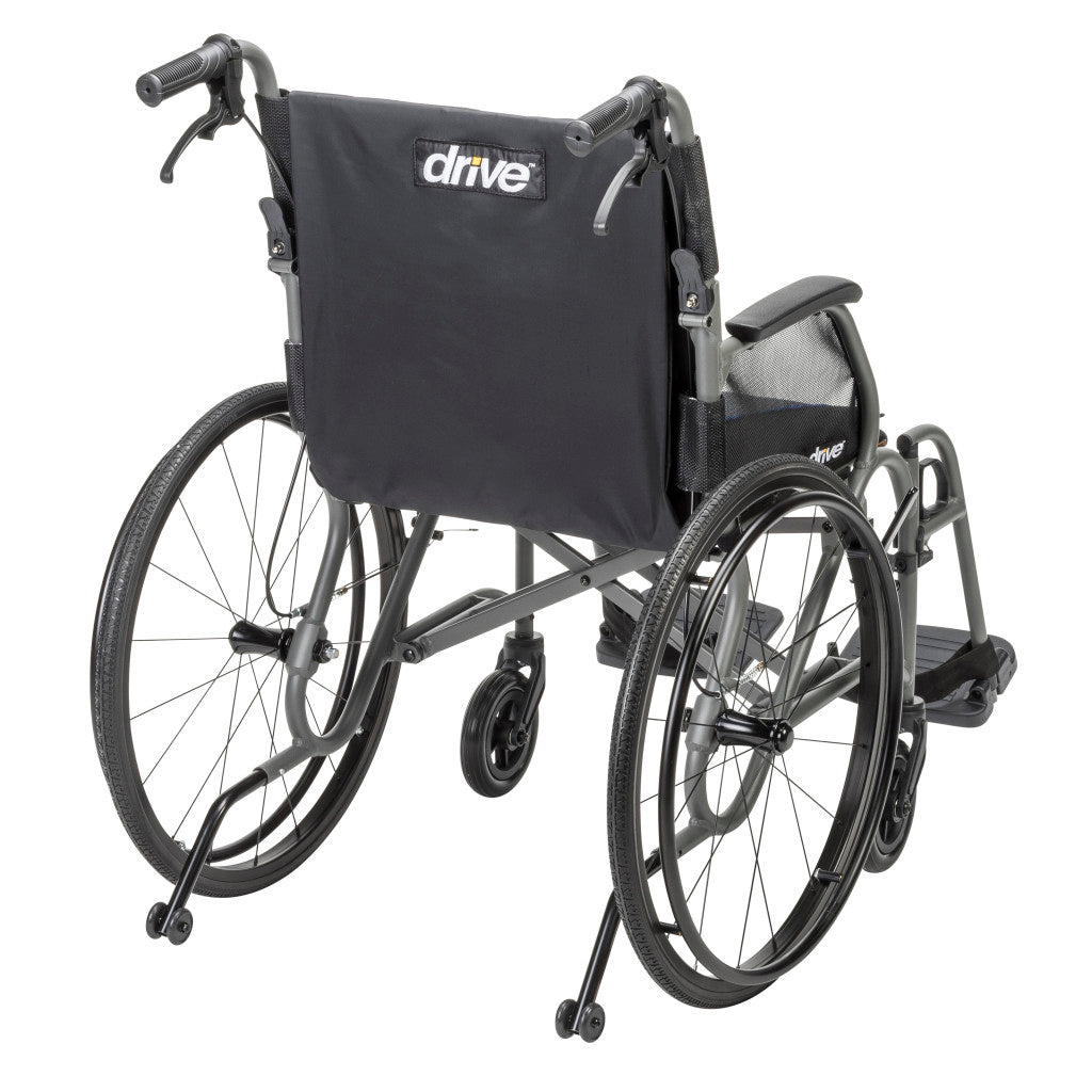 Rear angle of the gray AeroFly wheelchair showing the Drive-branded black backrest, push handles, rear wheels, and anti-tippers.