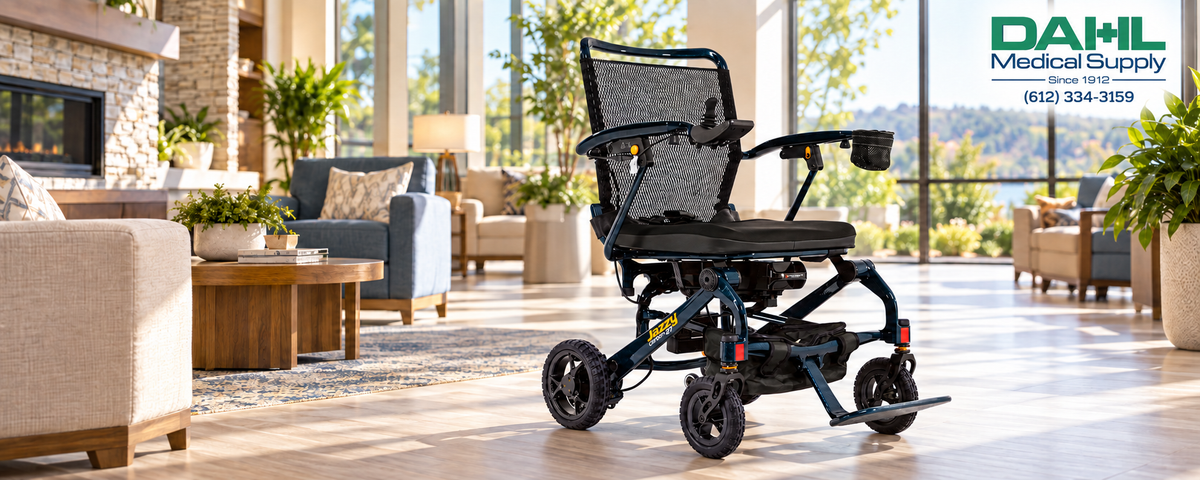 Night Sky Pride Jazzy Carbon 27 power wheelchair in a sunlit assisted living lounge, with the Dahl Medical Supply logo and phone number in the upper-right corner.
