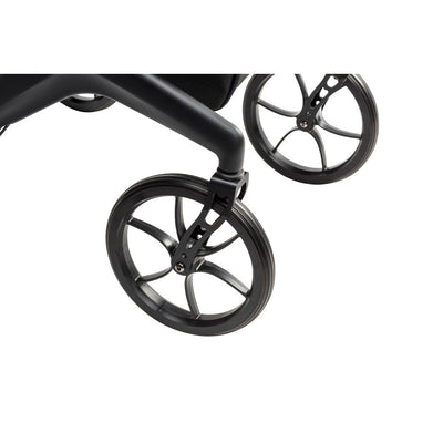 Close-up of the black AeroCarbon rollator’s front wheel, wheel fork, and carbon fiber frame.