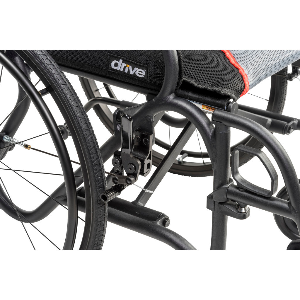 Close-up of the black AeroFly wheelchair frame beneath the seat, showing the folding mechanism and wheel assembly.