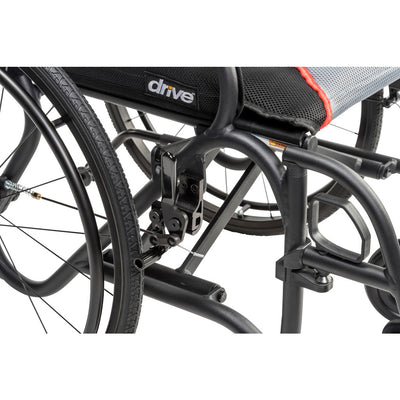 Close-up of the black AeroFly wheelchair frame beneath the seat, showing the folding mechanism and wheel assembly.
