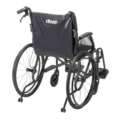 Rear angle of the black AeroFly wheelchair showing the Drive-branded backrest, push handles, rear wheels, and anti-tippers.