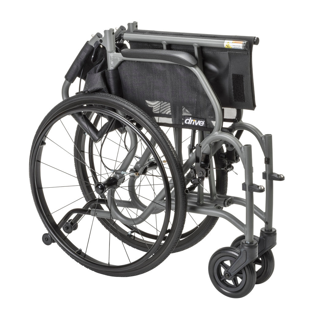 Gray AeroFly wheelchair folded for storage and transport, with the backrest lowered and rear wheels attached.