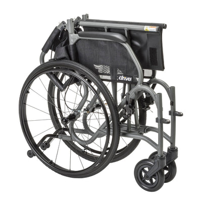 Gray AeroFly wheelchair folded for storage and transport, with the backrest lowered and rear wheels attached.