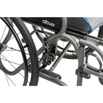 Close-up of the gray AeroFly wheelchair frame beneath the seat, showing the folding mechanism and wheel assembly.