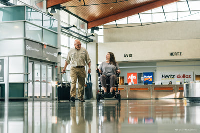 Traveler using the Pride Jazzy Carbon for convenient airport mobility.
