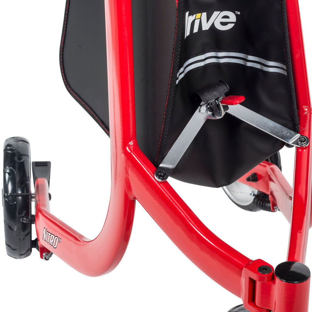 Close-up of the partially folded red Drive Nitro frame showing the hinged cross brace beneath the black storage bag.