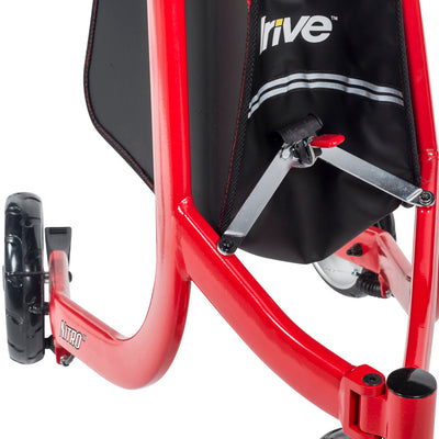 Close-up of the partially folded red Drive Nitro frame showing the hinged cross brace beneath the black storage bag.