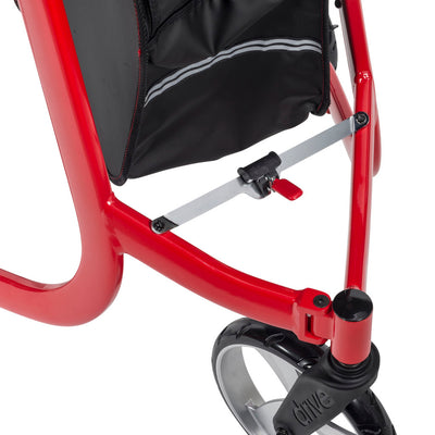 Close-up of the Drive Nitro rollator’s folding cross brace and red release tab beneath the storage bag.