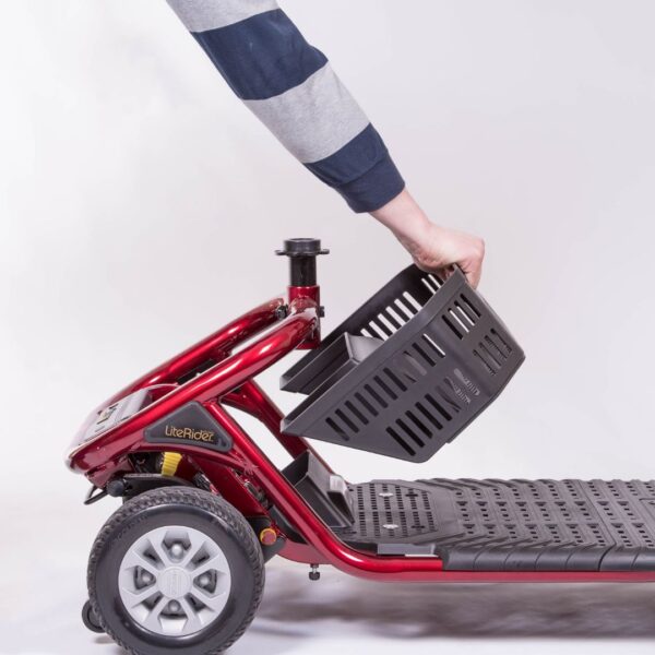 Under-seat storage basket being removed from the Golden LiteRider scooter for easy access, cleaning and transportation.