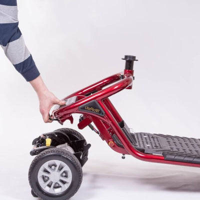 Close-up of the LiteRider scooter frame being separated from the rear drive section for easier transportation and storage.