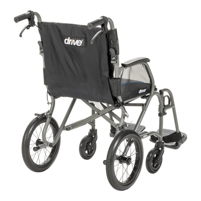 Rear angled view of the grey AeroFly transport wheelchair showing caregiver handles with brake levers, black backrest, and rear wheels.