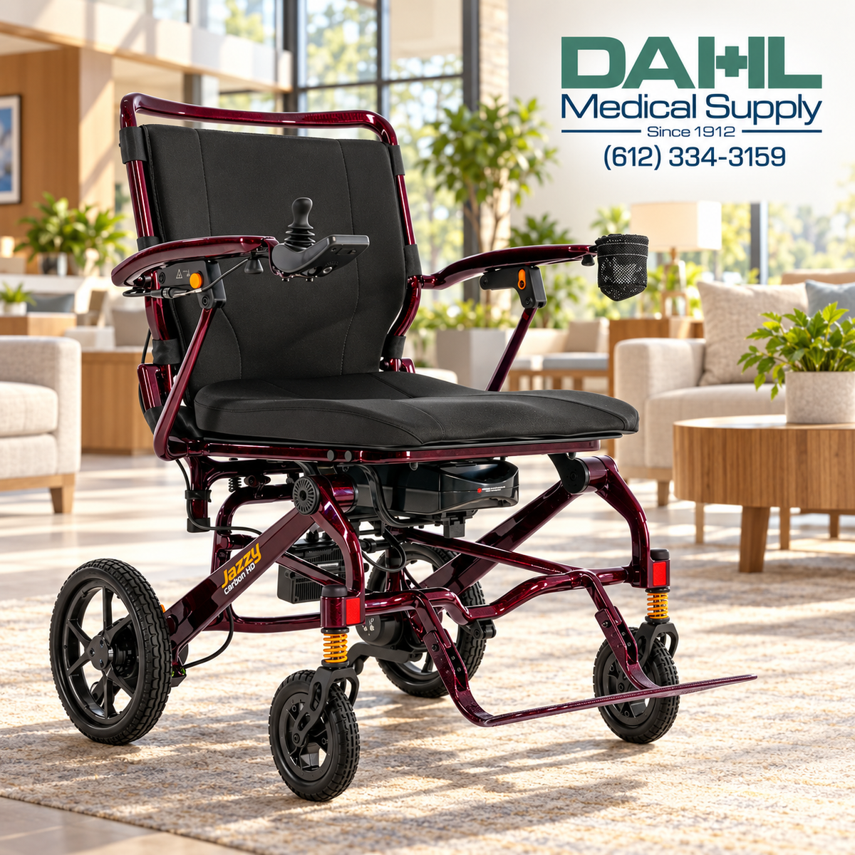 Black Cherry Jazzy Carbon HD power wheelchair in a bright independent living lounge, with the Dahl Medical Supply logo in the upper right corner.