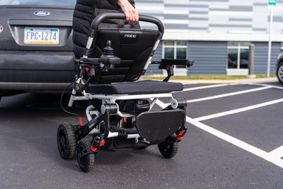 Pride Jazzy Carbon portable folding power wheelchair ready for travel.