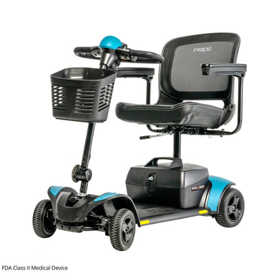 Three-quarter front view of the Pride Go Go Elite Traveller 2 travel scooter in Robin's Egg Blue showcasing its stable four-wheel design, ergonomic controls, and front storage basket.