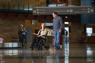 Compact folding power chair easily navigates busy airports and public spaces.