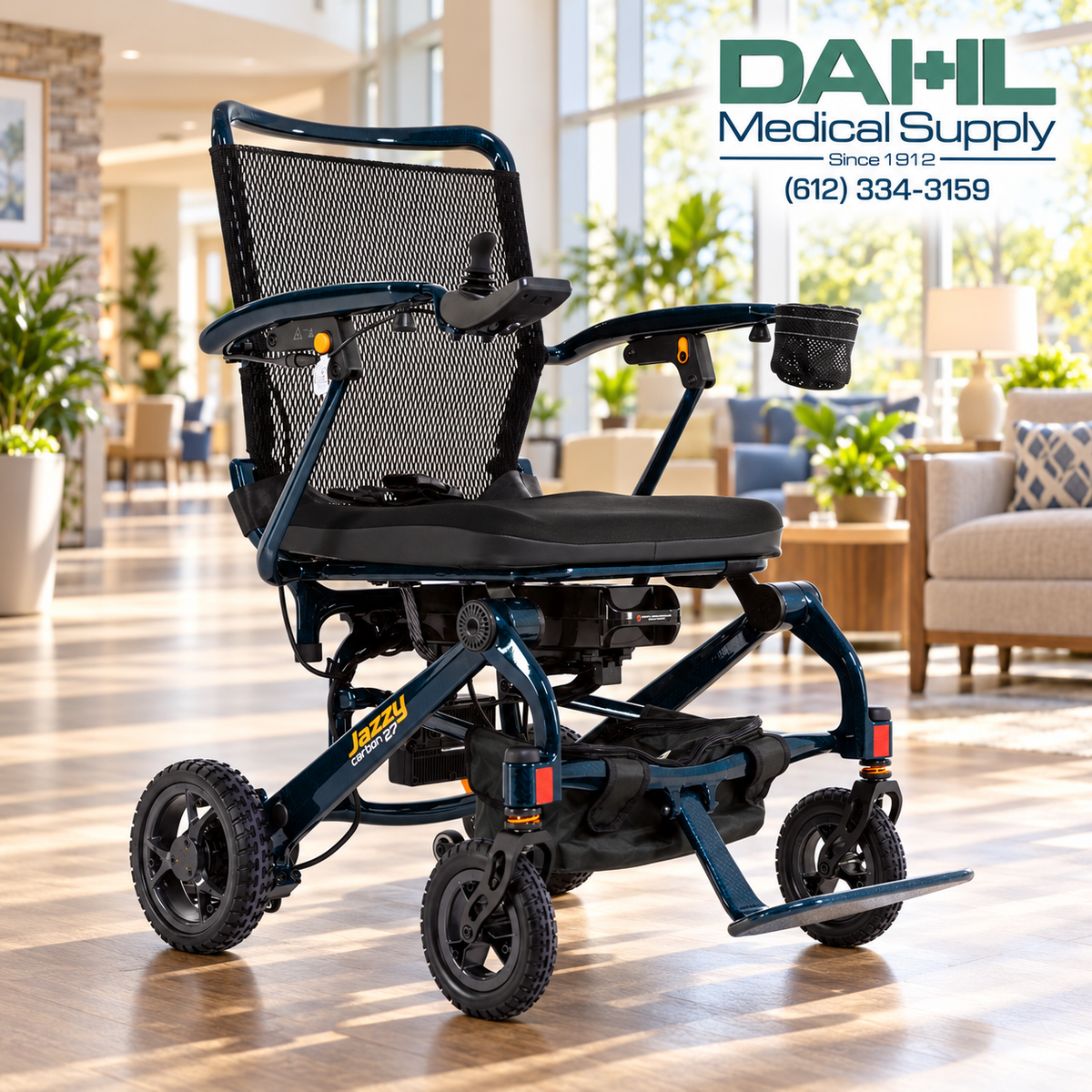 Night Sky Jazzy Carbon 27 power wheelchair in a bright assisted living lounge, with the Dahl Medical Supply logo in the upper right corner.