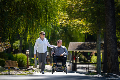Compact power wheelchair providing freedom on scenic outdoor pathways.