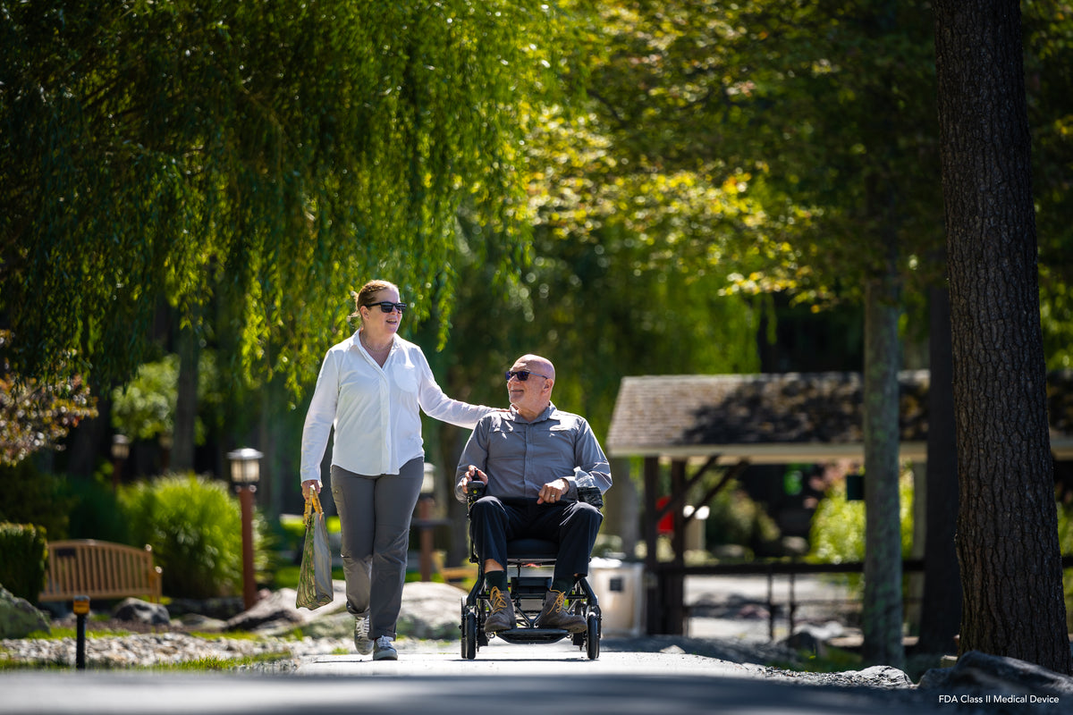 Compact power wheelchair providing freedom on scenic outdoor pathways.