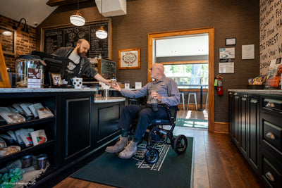 User enjoying easy mobility and independence inside a coffee shop.
