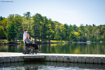 User enjoying lakeside views with the portable Jazzy Ultra Light power chair.