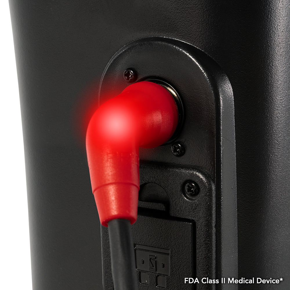 Close-up of an illuminated red charging connector plugged into the Pride Victory Platinum mobility scooter’s charging port.