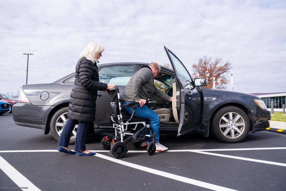 User transferring from the Pride Jazzy Carbon into a vehicle seat.